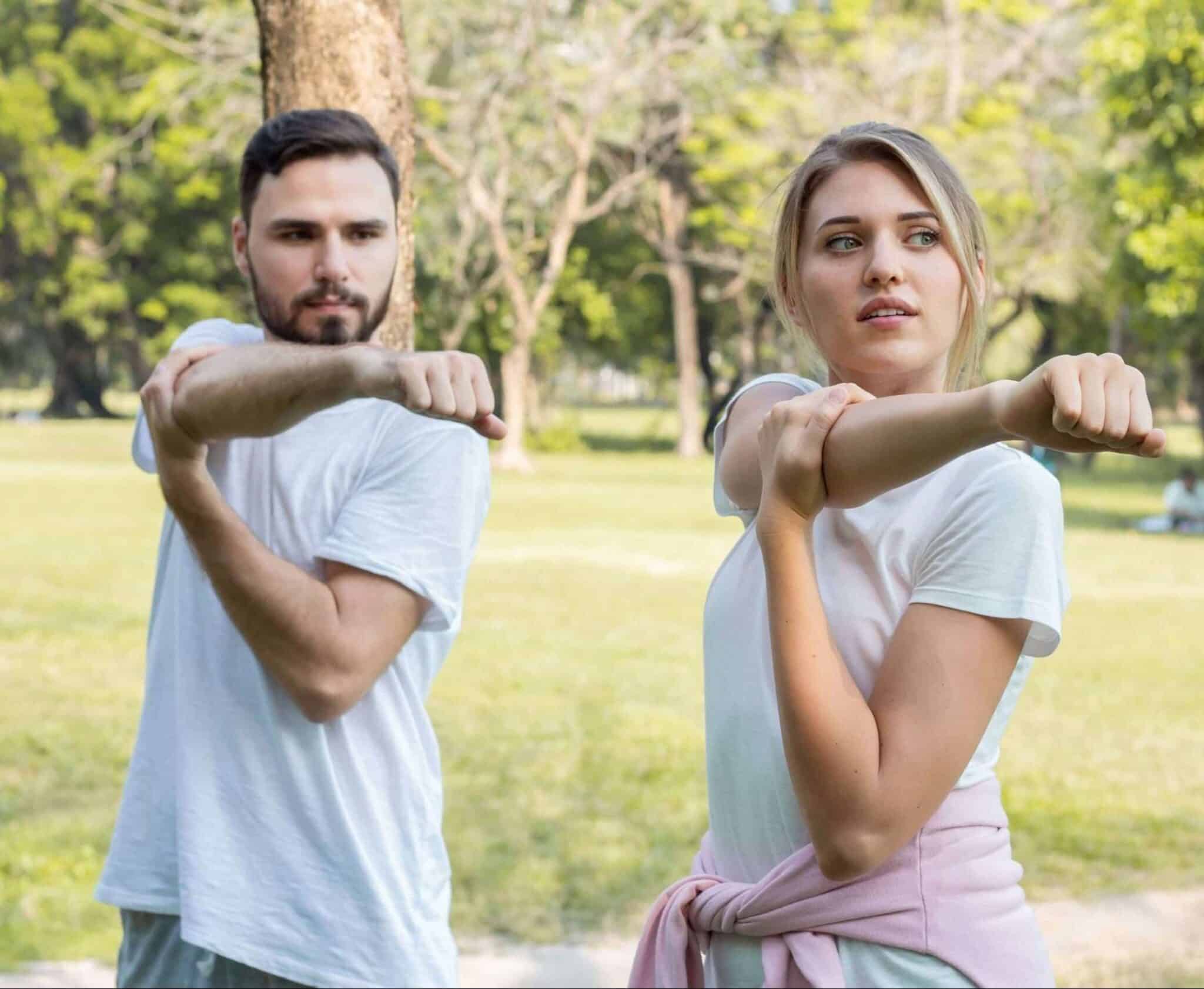 Young Caucasian couples exercise together in the park.